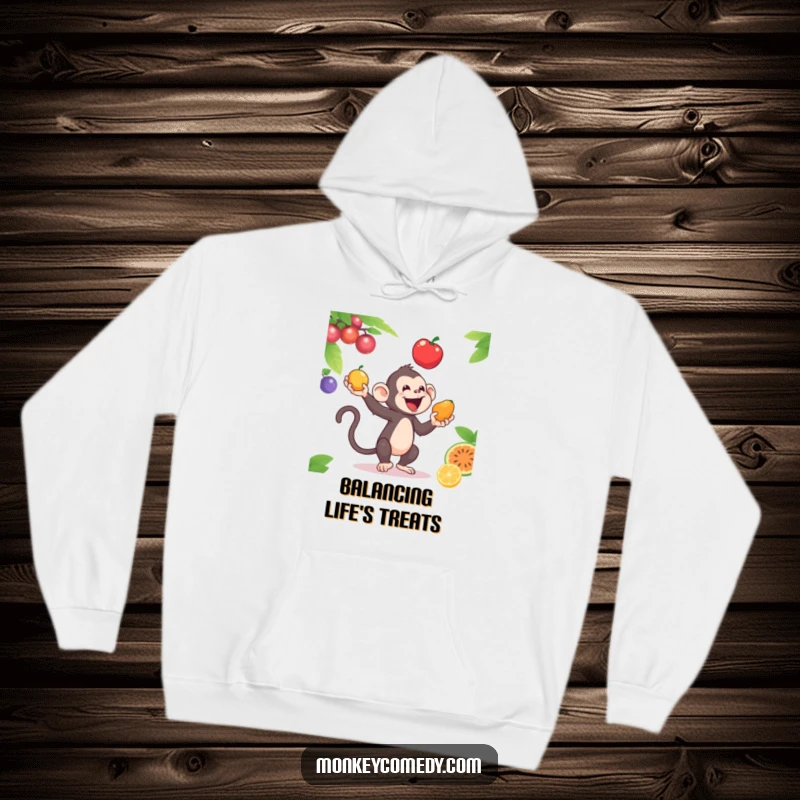 Funny hoodie displaying a talented monkey juggling three bright fruits, symbolizing skill and a zest for life.