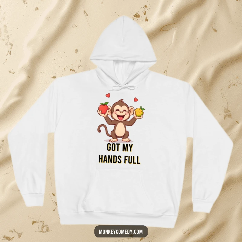 Funny Hoodie: A giggling monkey juggles fruits with hands and feet, bringing cozy fun and humor.
