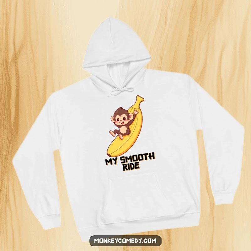 Funny monkey sliding down a banana peel on a cozy hoodie, perfect for gifts.