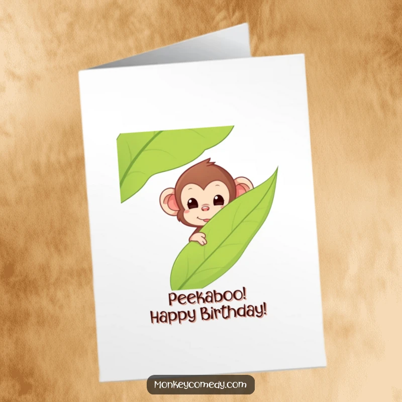 Funny Free Printable Birthday Card: Kawaii monkey with big eyes peeking playfully from behind a large green leaf.
