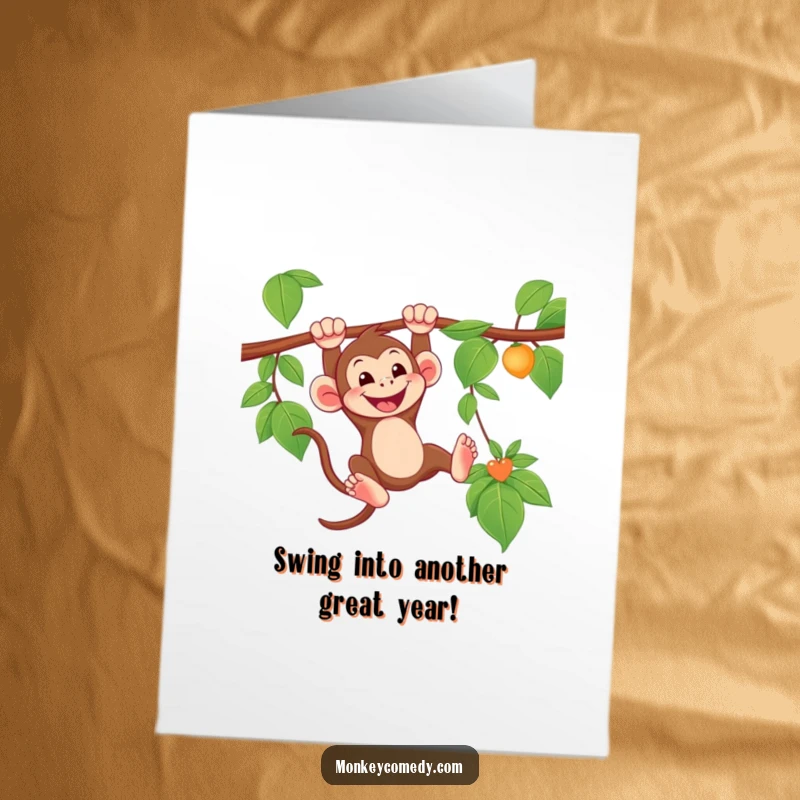 Free Printable Birthday Card: A monkey grins widely while swinging joyfully from a lush green vine.